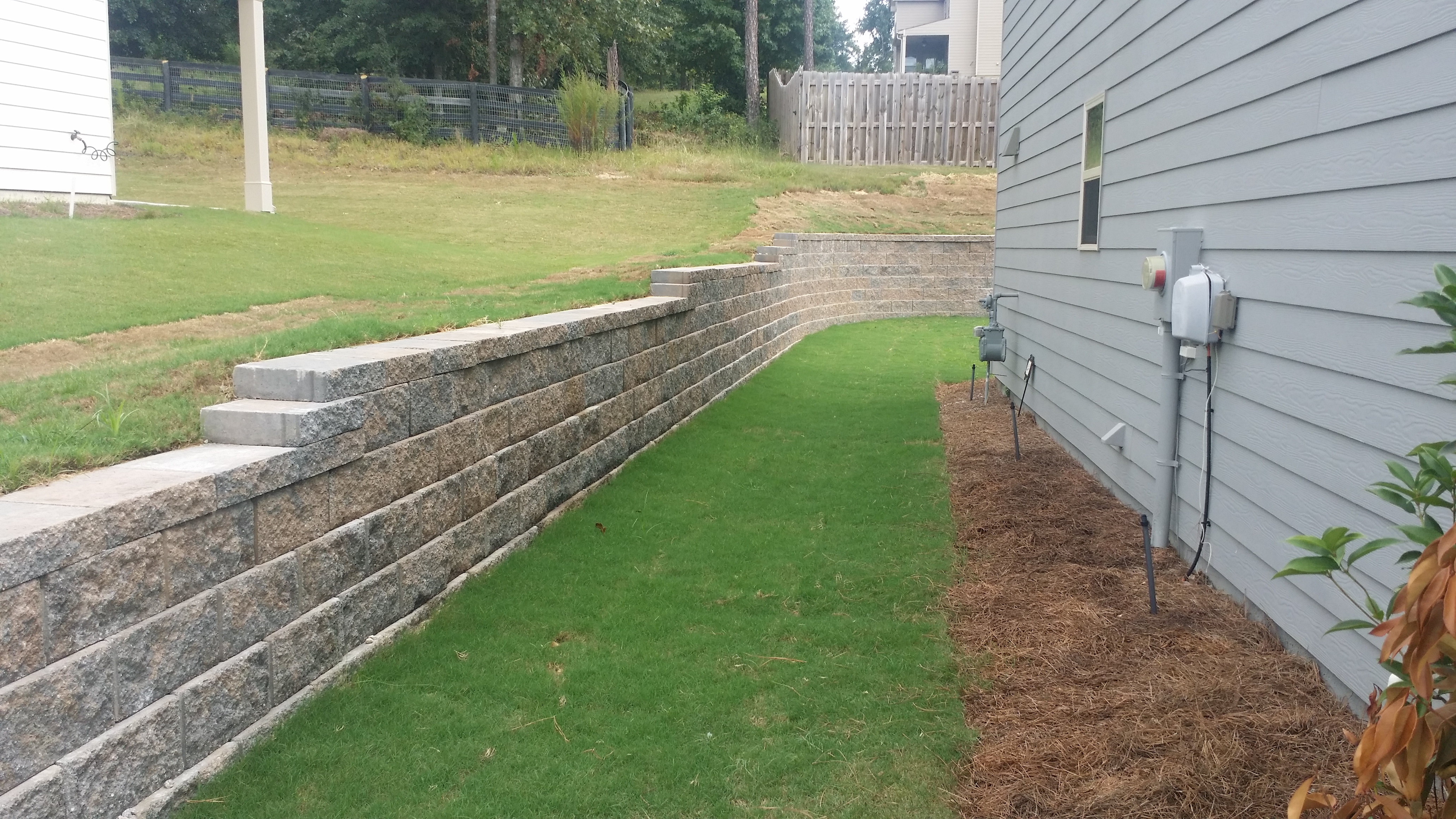 Retaining wall in landscaped yard